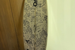 Omri Ram's surfboard signed by his friends. He was killed on October 7.